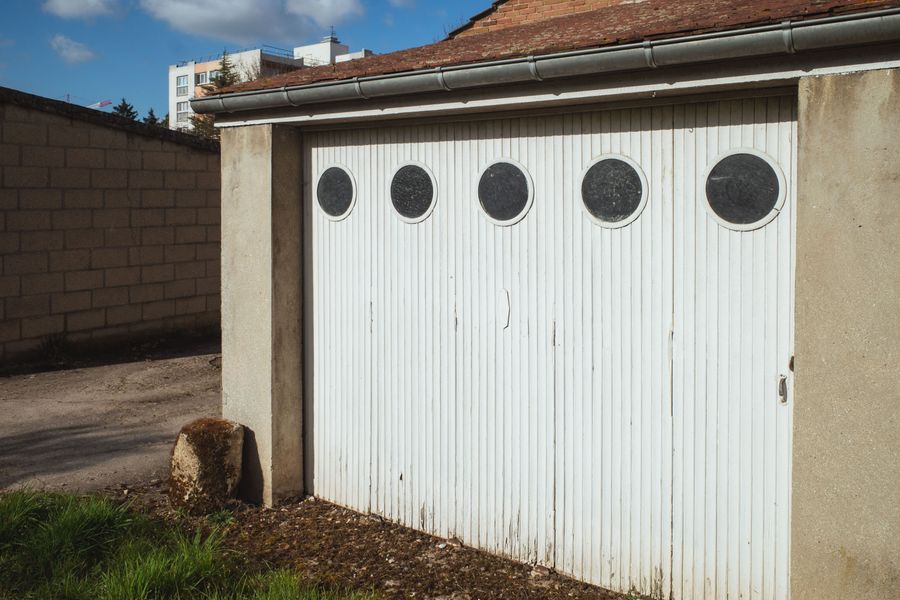 White garage door with round glazing panels