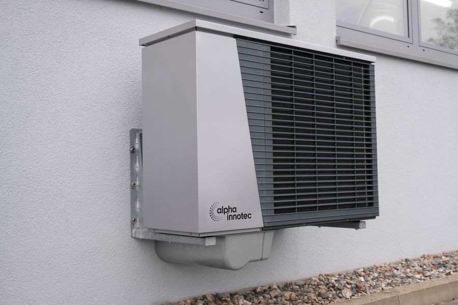 Outdoor heat-pump and air-conditioning unit mounted on a house wall